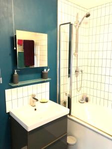a bathroom with a sink and a shower at Balcarres, Rodborough Avenue in Stroud