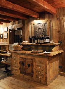 a kitchen with a counter with bottles of wine at La Rêverie de Thumel - Suite in Rhêmes-Notre-Dame