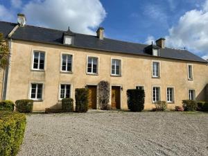 a large house with a driveway in front of it at Le Clos du Bas Courtil Guesthouse B&B Omaha Beach in Osmanville
