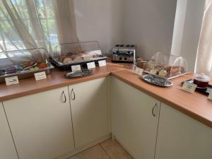 a kitchen counter with bread and other foods on it at Perla Beach in Agia Marina Nea Kydonias