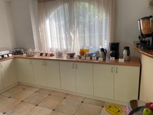 a kitchen with a counter top with a window at Perla Beach in Agia Marina Nea Kydonias