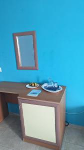 a table with a mirror and a plate of fruit on it at Guest House Chalakov in Sinemorets