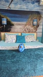 a large bed with a stuffed animal sitting on it at Guest House Chalakov in Sinemorets