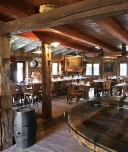 a restaurant with wooden tables and chairs in a room at La Rêverie de Thumel - Suite in Rhêmes-Notre-Dame