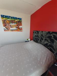 ein Schlafzimmer mit einem Bett und einem Wandgemälde in der Unterkunft Chambre d'hôte près de Paris in Épinay-sur-Seine
