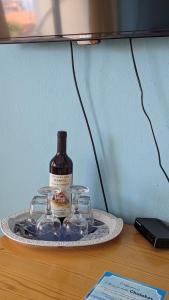 a tray with a bottle of wine and glasses on a table at Guest House Chalakov in Sinemorets