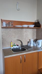 a kitchen with a sink and a counter top at Guest House Chalakov in Sinemorets