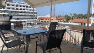 a patio with a table and chairs and a building at Unique City Hostel 100 meters from Beach in Larnaka