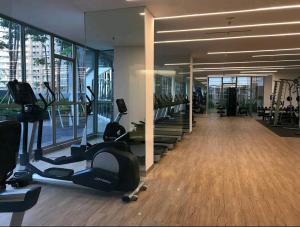 a gym with treadmills and exercise equipment in a building at Studio Apartment at Gold Coast PIK in Jakarta