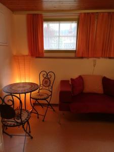 a living room with a couch and a table at Ferienzimmer Appenzell in Appenzell