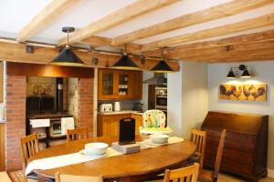 a kitchen and dining room with a wooden table at Deepmoor Farmhouse, Doveridge, Derbys. in Doveridge