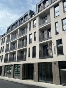 an apartment building with balconies on the side of it at Widok Kielce - Apartament przy Rynku in Kielce