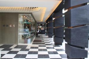 a hallway of a store with a checkered floor at Century Hotel in Kaohsiung