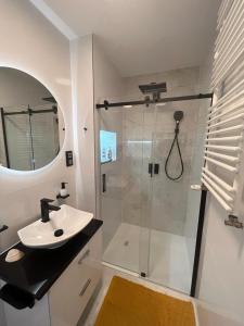 a bathroom with a shower and a sink at Widok Kielce - Apartament przy Rynku in Kielce