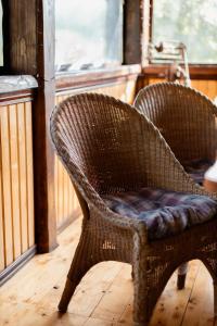 a wicker chair sitting on a wooden floor at Rest houses FORUMS in Oriv