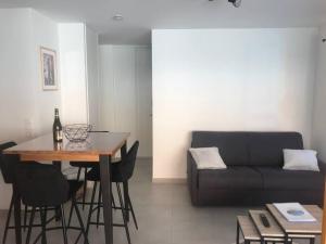 ein Wohnzimmer mit einem Tisch und einem Sofa in der Unterkunft studio 3 *** centre village Saint-Jean-de-Sixt in Saint-Jean-de-Sixt
