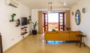 a living room with a yellow couch in a room at Ocean View Apartment D7 in Mombasa