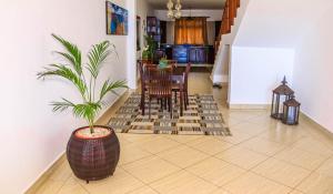 a living room with a potted plant on the floor at Ocean View Apartment D7 in Mombasa