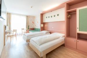 A bed or beds in a room at JUFA Hotel Stubenbergsee