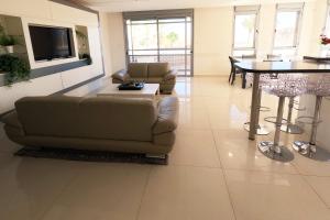 a living room with a couch and a table at YalaRent Villa Dolina with private pool in Eilat