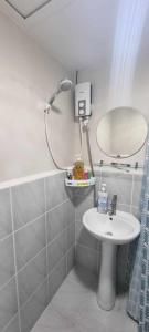 a small bathroom with a sink and a mirror at Ohana Suites Lapu-Lapu City Condo Staycation Near Mactan International Airport in Lapu Lapu City