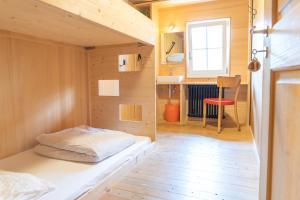 a small room with a bed in a tiny house at Naturfreunde Hostel Grindelwald in Grindelwald