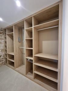 a closet with wooden shelves in a room at Casa Casco Antiguo in Linares