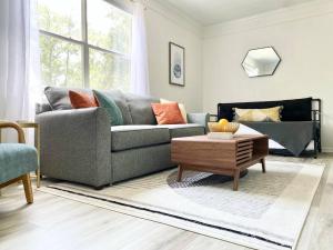 a living room with a couch and a coffee table at Sanctuary at Oaks - Full Kitchen , Near I75 in Gainesville