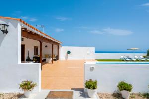 a villa with a view of the ocean at Private house with pool & garden in Güimar