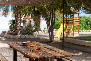 a wooden table with a bowl of food and a slide at Private house with pool & garden in Güimar