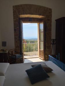 a bedroom with a bed and a door to a balcony at La Villa di Minerva in Agrigento