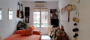 a bedroom with a bed with orange pillows in it at Old town Marbella home in Marbella