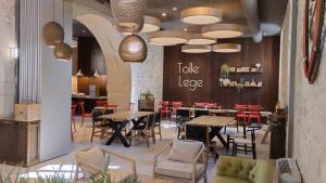 a restaurant with tables and chairs and a table logo at HOTEL Hospedería Monasterio de La Vid in La Vid y Barrios