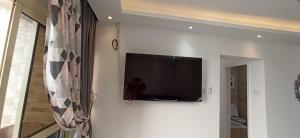 a flat screen tv hanging on a white wall at شقة فاخرة علي البحر مباشرة لوران الاسكندرية in Alexandria