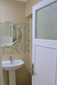 a bathroom with a sink and a mirror at شقة فاخرة علي البحر مباشرة لوران الاسكندرية in Alexandria