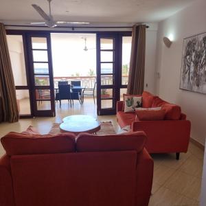 a living room with two couches and a table at Ocean View Apartment D5 in Mombasa