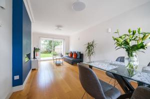 a dining room and living room with a table and chairs at 2 bed semi-detached house to rent in Connaught Road, Barnet EN5 in Barnet