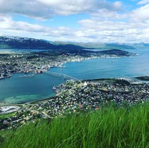 an aerial view of a city and a body of water at Sentral og koselig leilighet in Tromsø