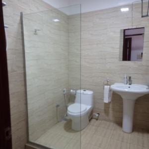 a bathroom with a toilet and a sink at Ocean View Apartment D5 in Mombasa +24 photos