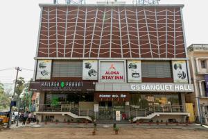 a large building with a sign on the side of it at Aloka Stay Inn in Vellore