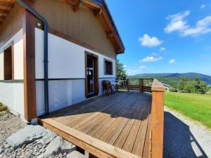 a wooden deck on the side of a house at Gîte Les sepneilles ! in Gérardmer