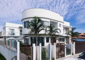 a large white building with a dome on top of it at La Plage Residence in Garopaba