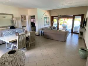 a living room with a couch and a table at Grand Baie Beach Penthouse in Grand Baie