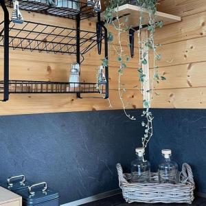 a kitchen with a shelf and two glass bottles on a basket at AQUACHILL houseboat & wellness in Liptovský Trnovec