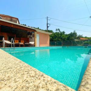 a swimming pool in front of a house at VARANDA DO ABELHAL in Baião