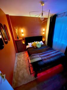 a bedroom with a bed with orange walls at Exotic spa in Poissy