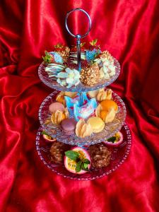 two tiers of cookies and other snacks on a red blanket at Exotic spa in Poissy