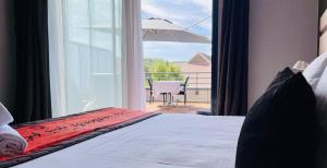 a bedroom with a bed and a view of a patio at Au Coeur Des Bulles in Loches-sur-Ource