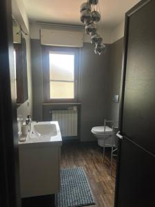 a bathroom with a sink and a toilet and a window at PennysHouse in San Giovanni Teatino