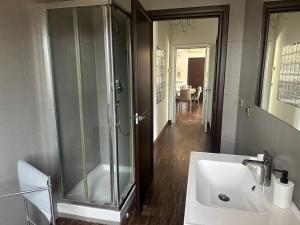 a bathroom with a sink and a glass shower at PennysHouse in San Giovanni Teatino